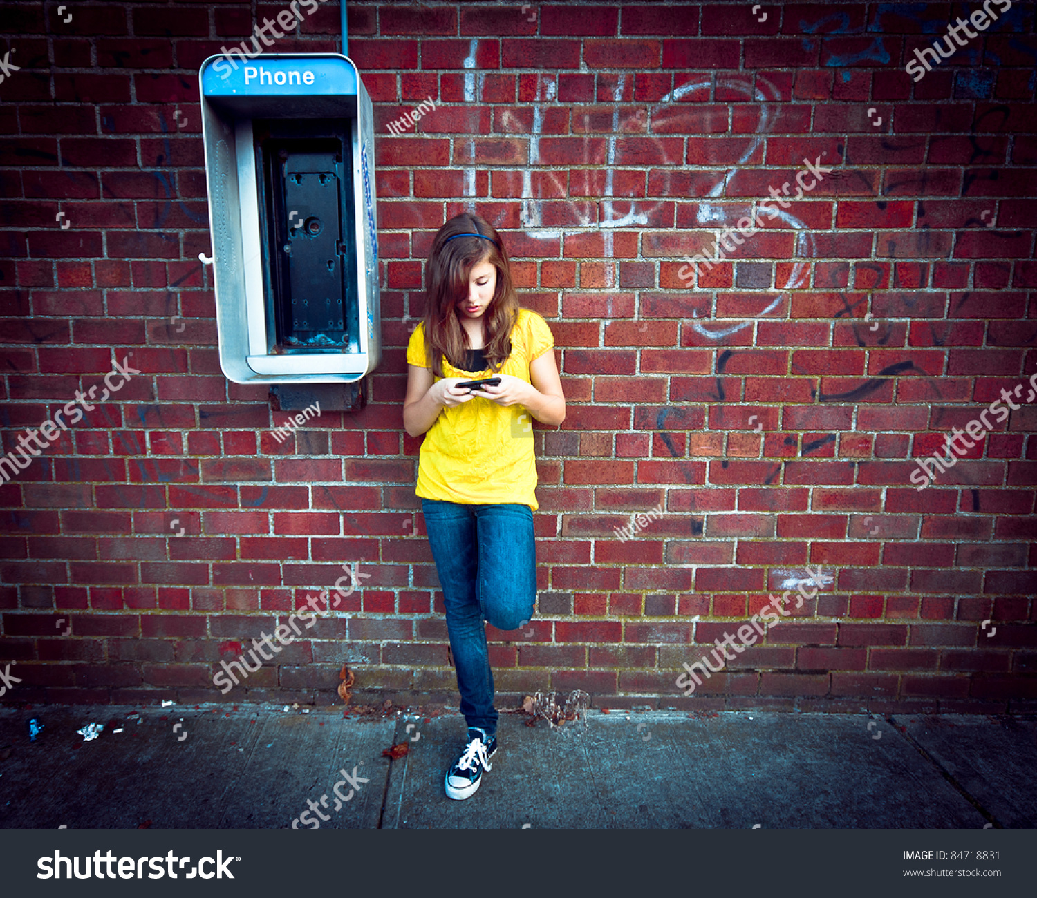Gitty Image Of A Girl Texting On Her Cell Phone Next To An Old Out Of ...