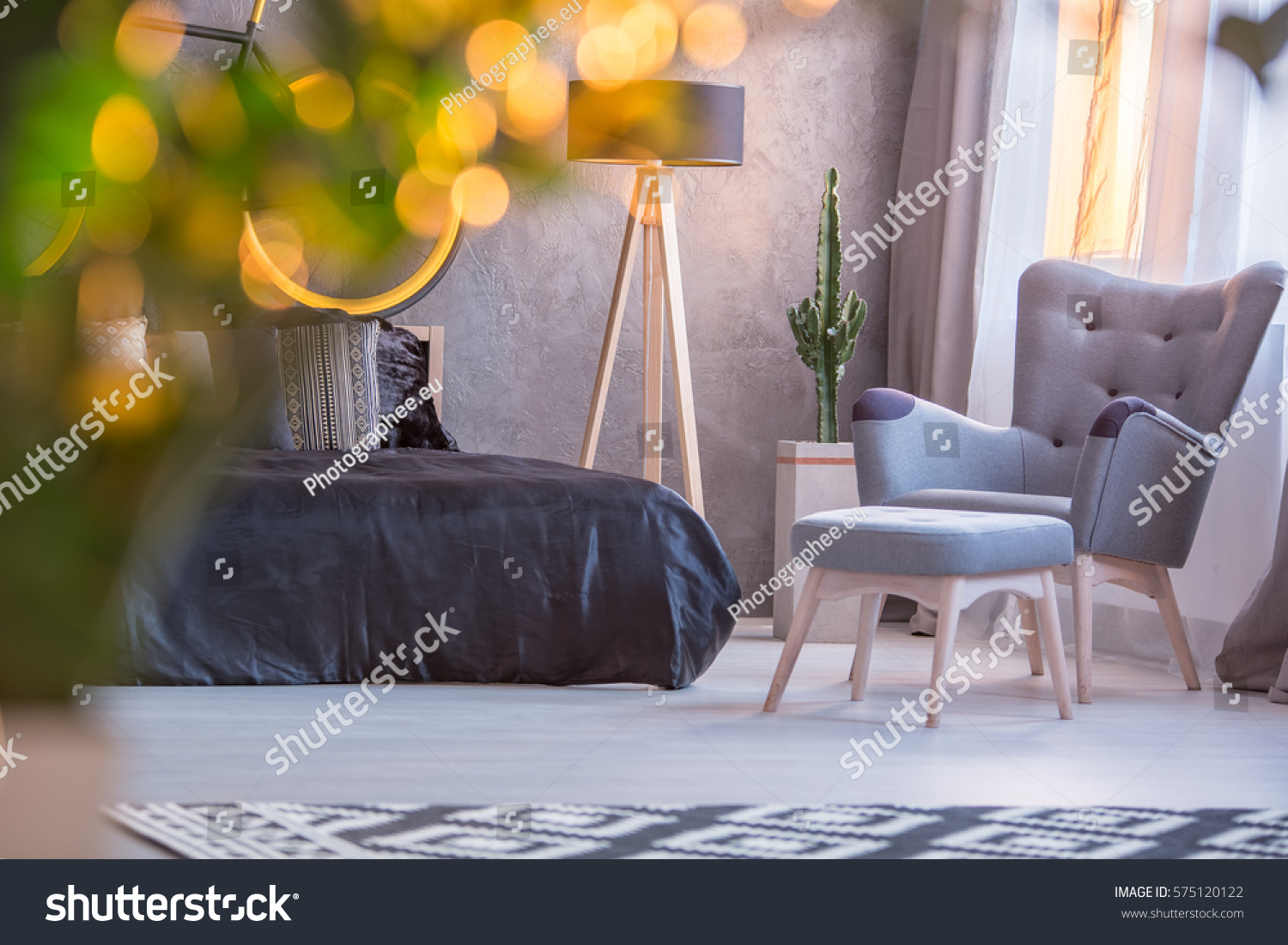 grey bedroom black bed armchair footstool stock photo edit