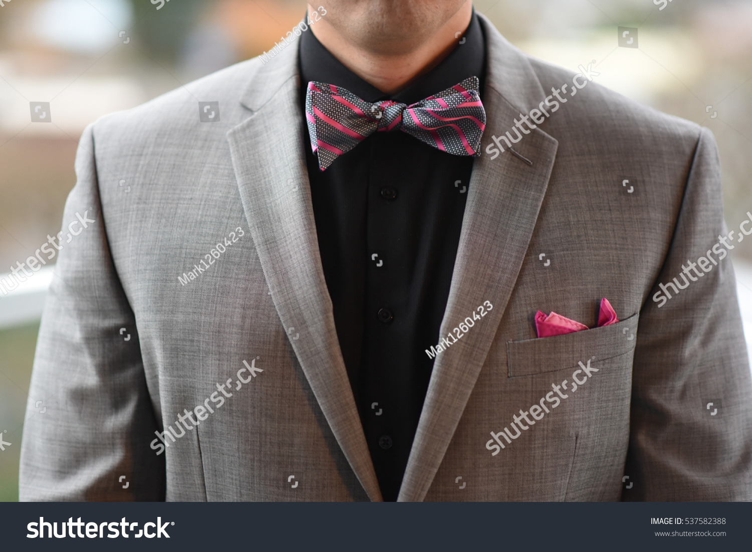 gray suit red bow tie