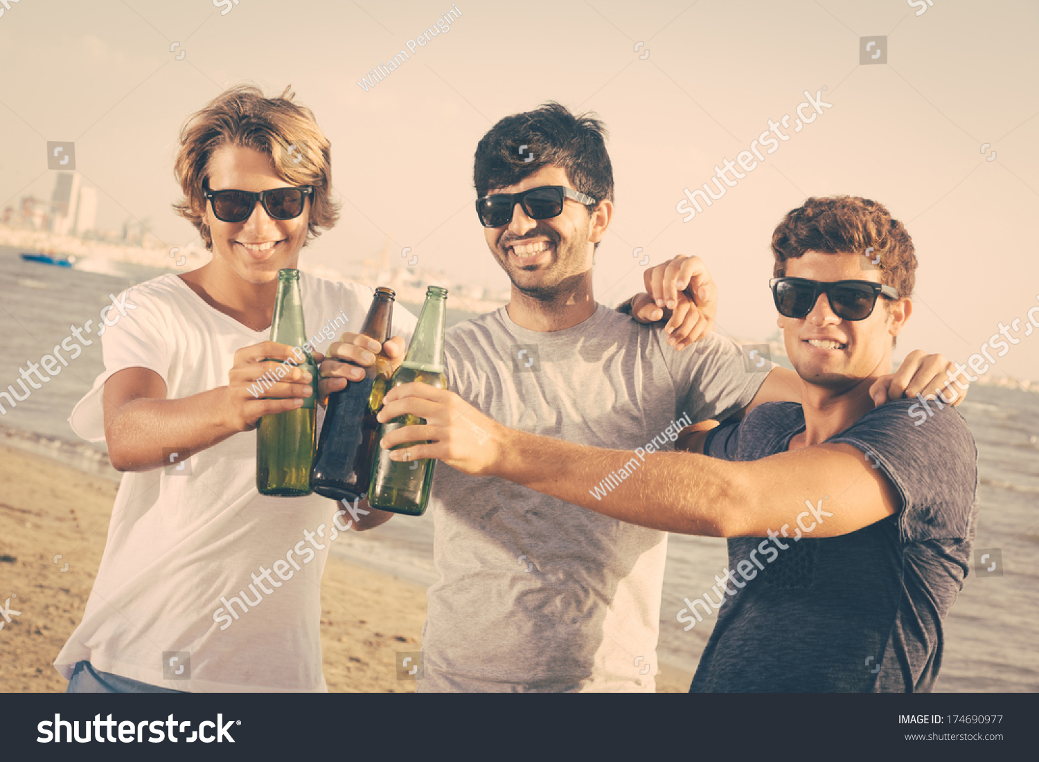 Group Of Boys Cheering At Beach Stock Photo 174690977 : Shutterstock