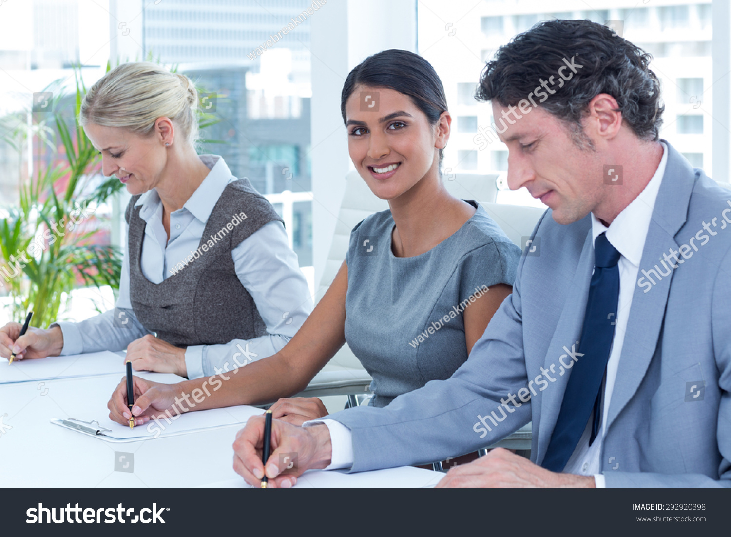 Group Of Business People Taking Notes In An Office Stock Photo ...