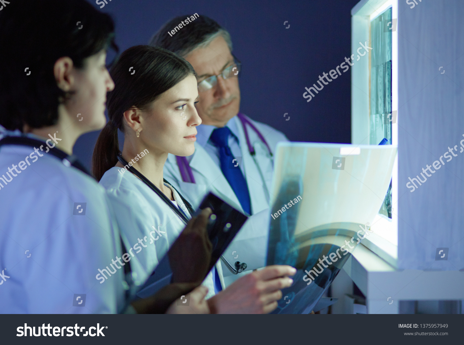 Group Doctors Examining Xrays Clinic Thinking Stock Photo 1375957949 ...