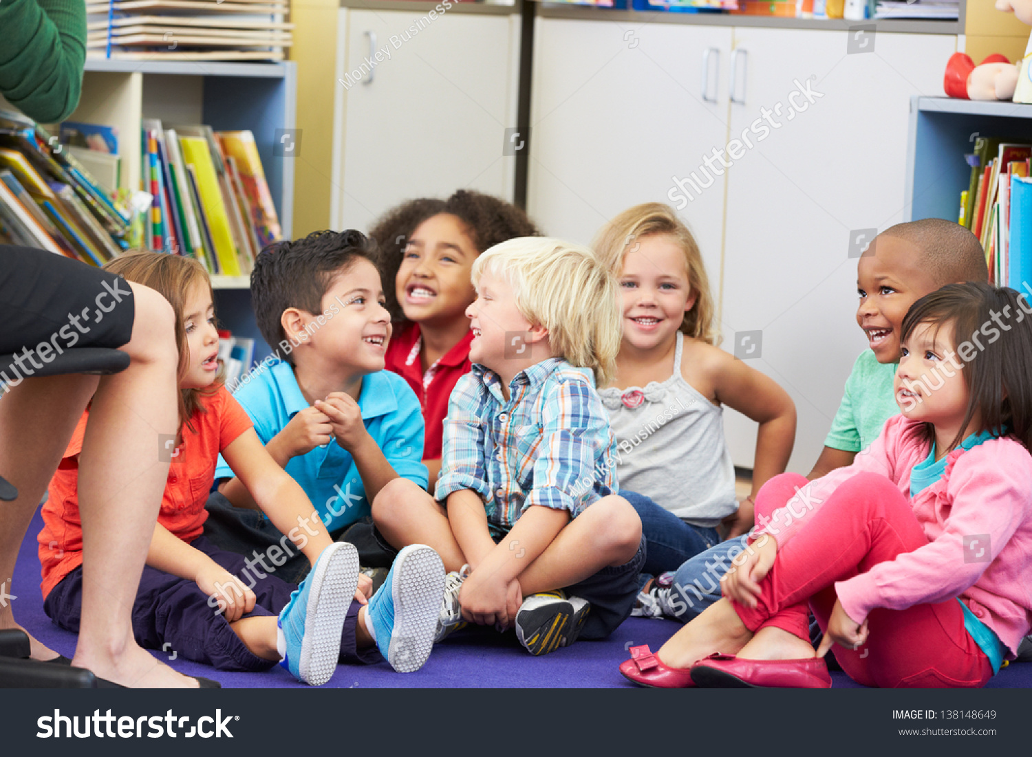 Group Of Elementary Pupils In Classroom Listening To Teacher Stock ...