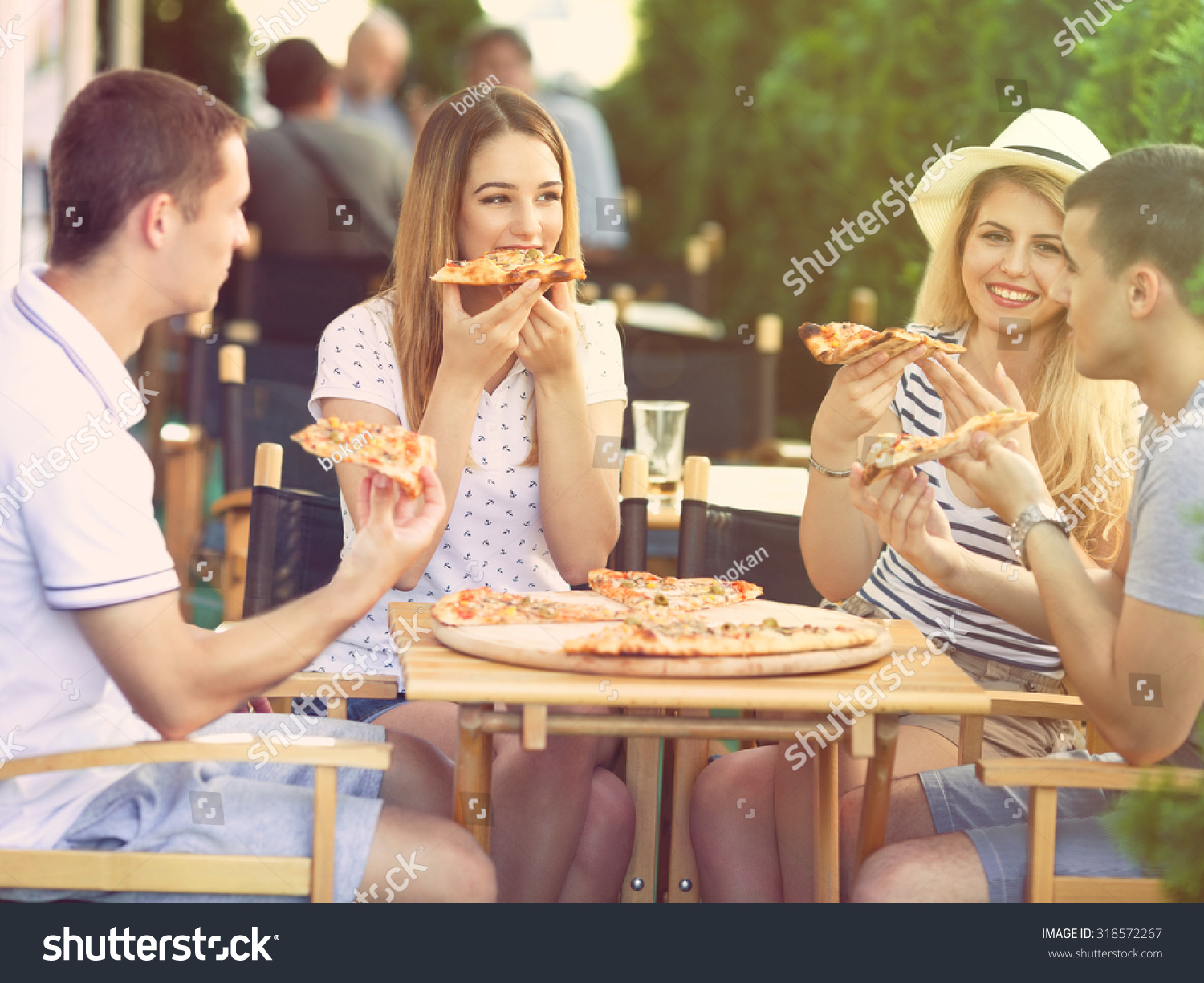 Group Of Happy Young People Eating Pizza In A Restaurant Stock Photo ...