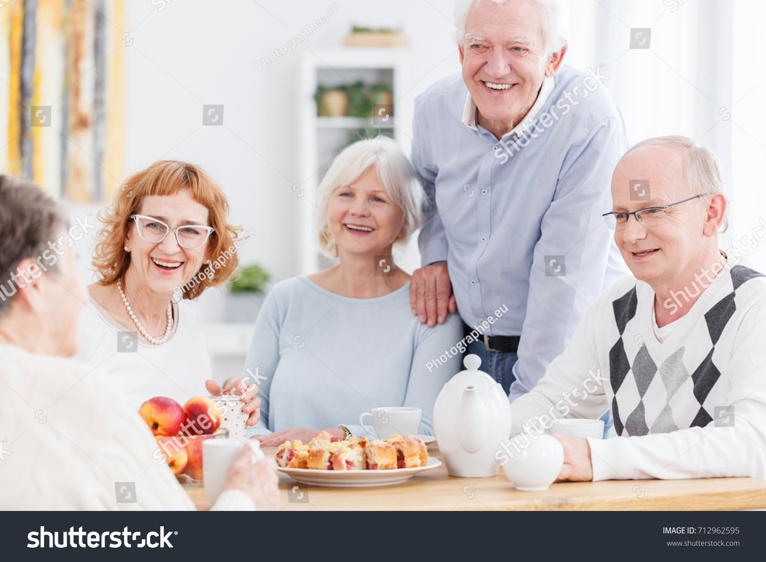 Group Smiling Elderly People Sitting Table Stock Photo 712962595 ...