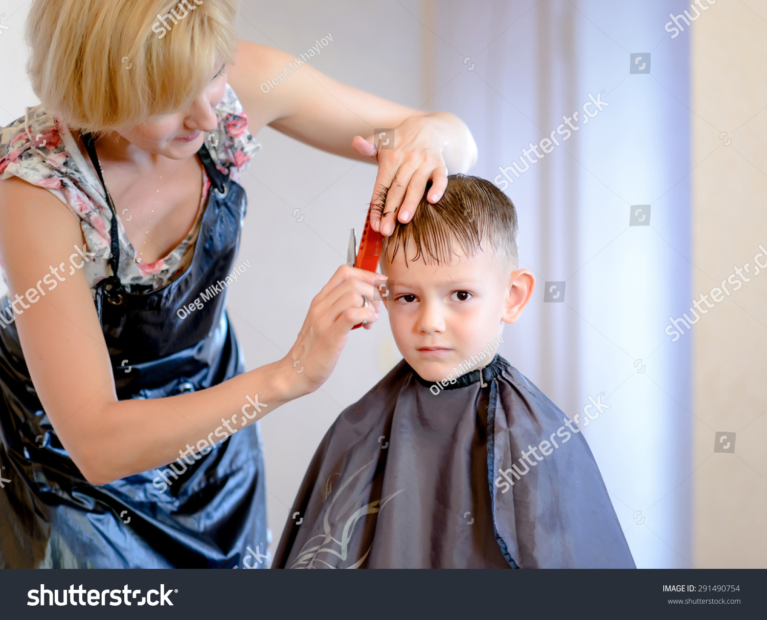 Hairdresser Cutting Little Boys Hair Into Royalty Free Stock Image