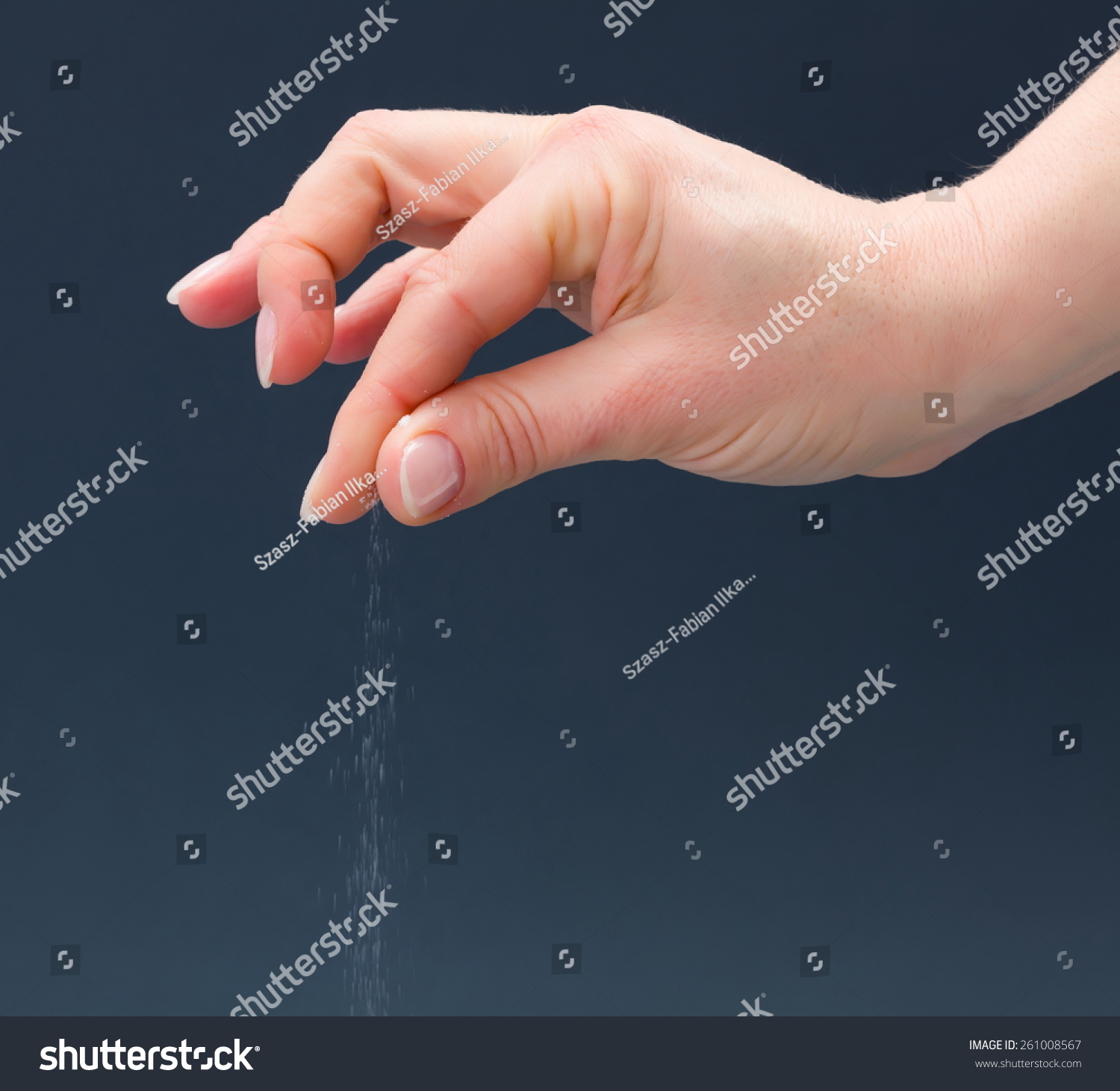 Hand Sprinkling Salt On Gray Background Stock Photo 261008567 ...