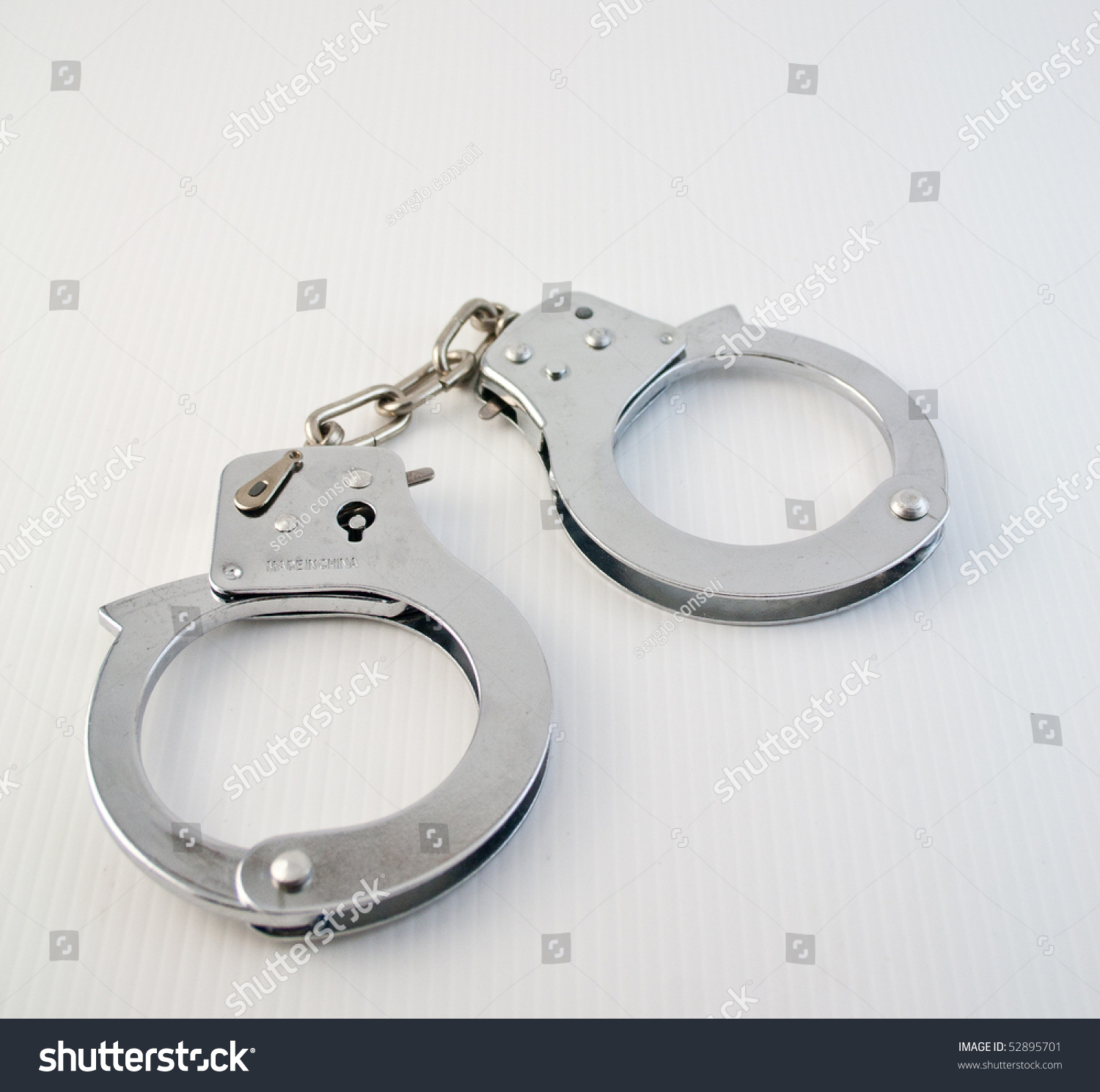 Handcuffs On A White Ground Stock Photo 52895701 : Shutterstock