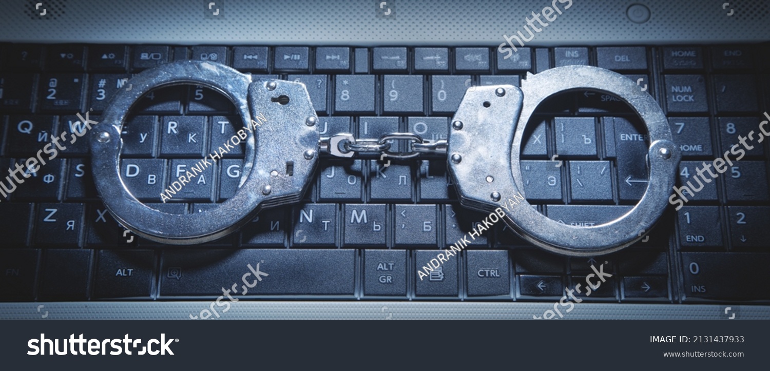 Handcuffs On Computer Keyboard Cyber Crime Stock Photo 2131437933 ...