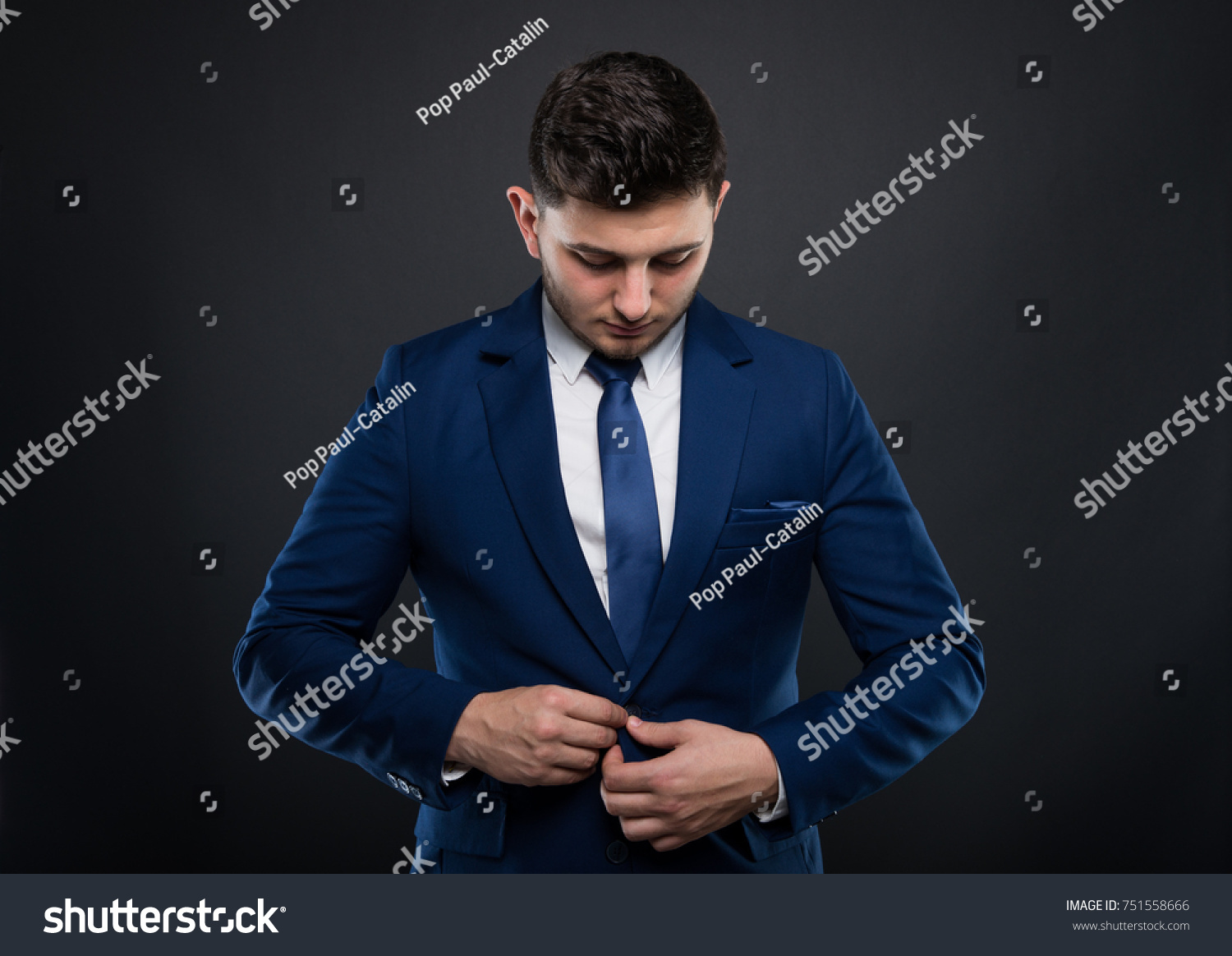 Handsome Businessman Buttoning His Suit Jacket Stock Photo 751558666