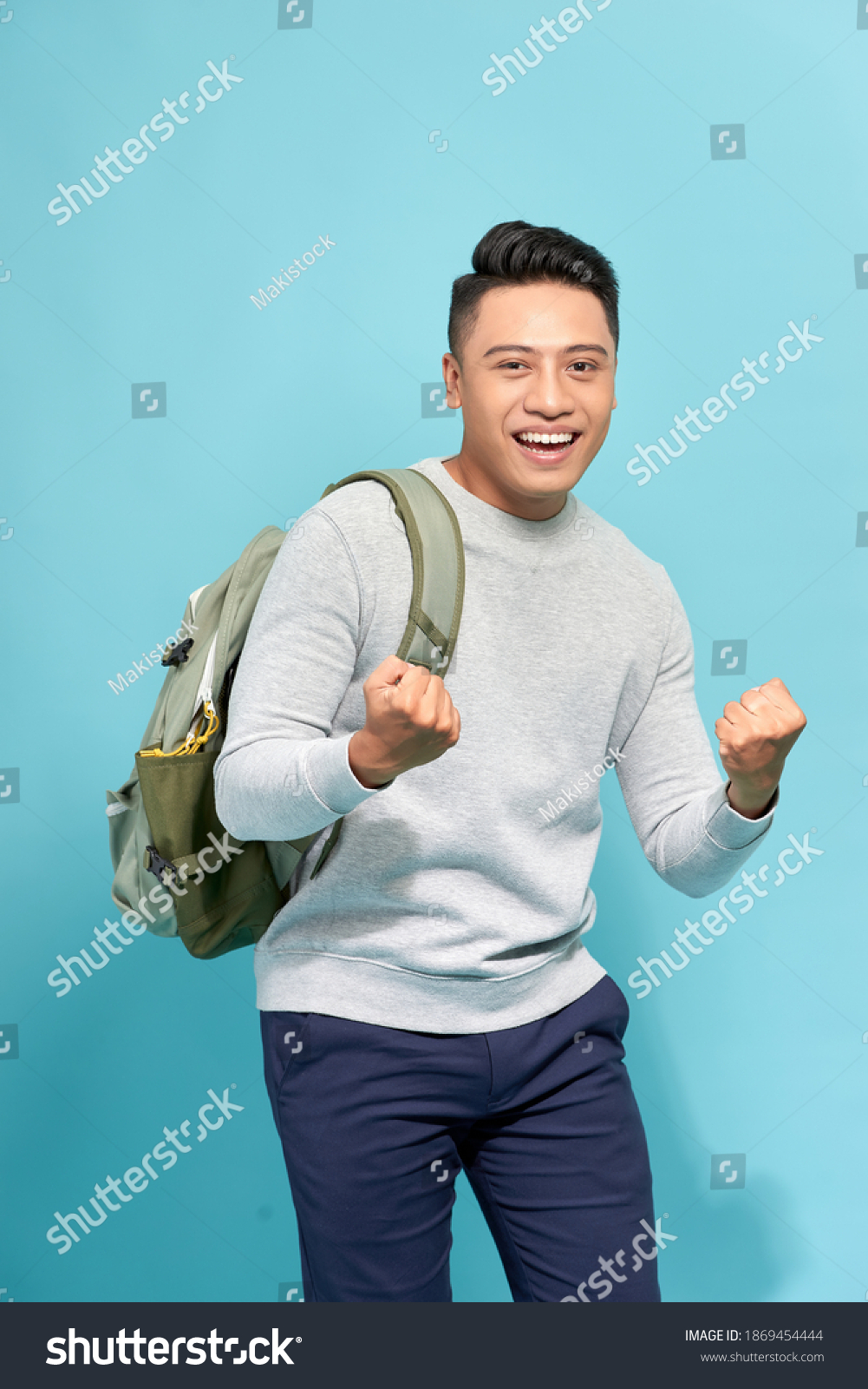 Handsome Guy Celebrating Prize Raised Hands Stock Photo 1869454444