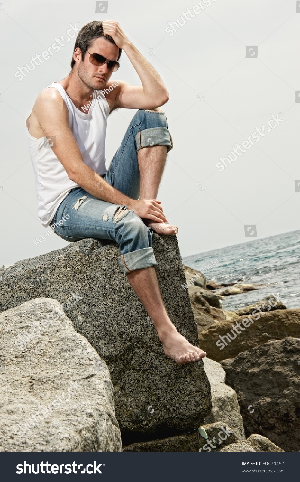 Handsome Man Sitting On Rock Stock Photo 80474497 - Shutterstock