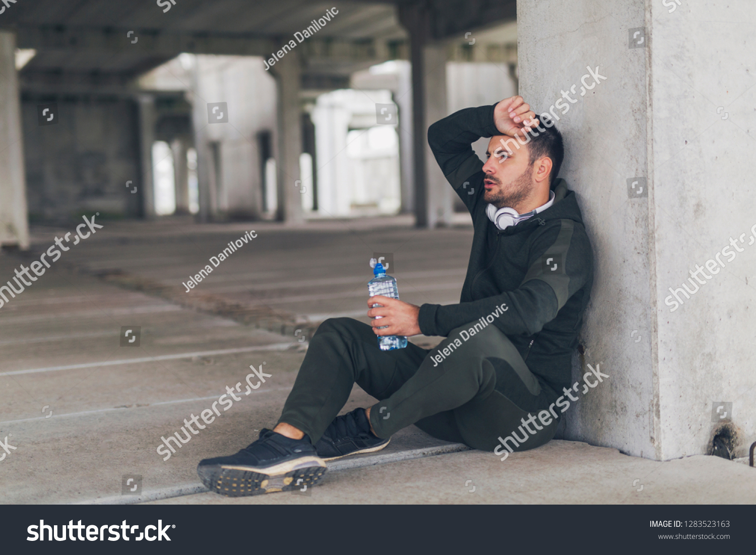 Handsome Man Sitting On Ground Making Stock Photo (Edit Now) 1283523163