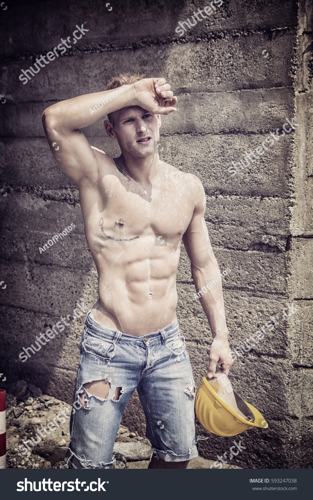 Handsome Muscular Construction Worker Standing Shirtless Stock Photo