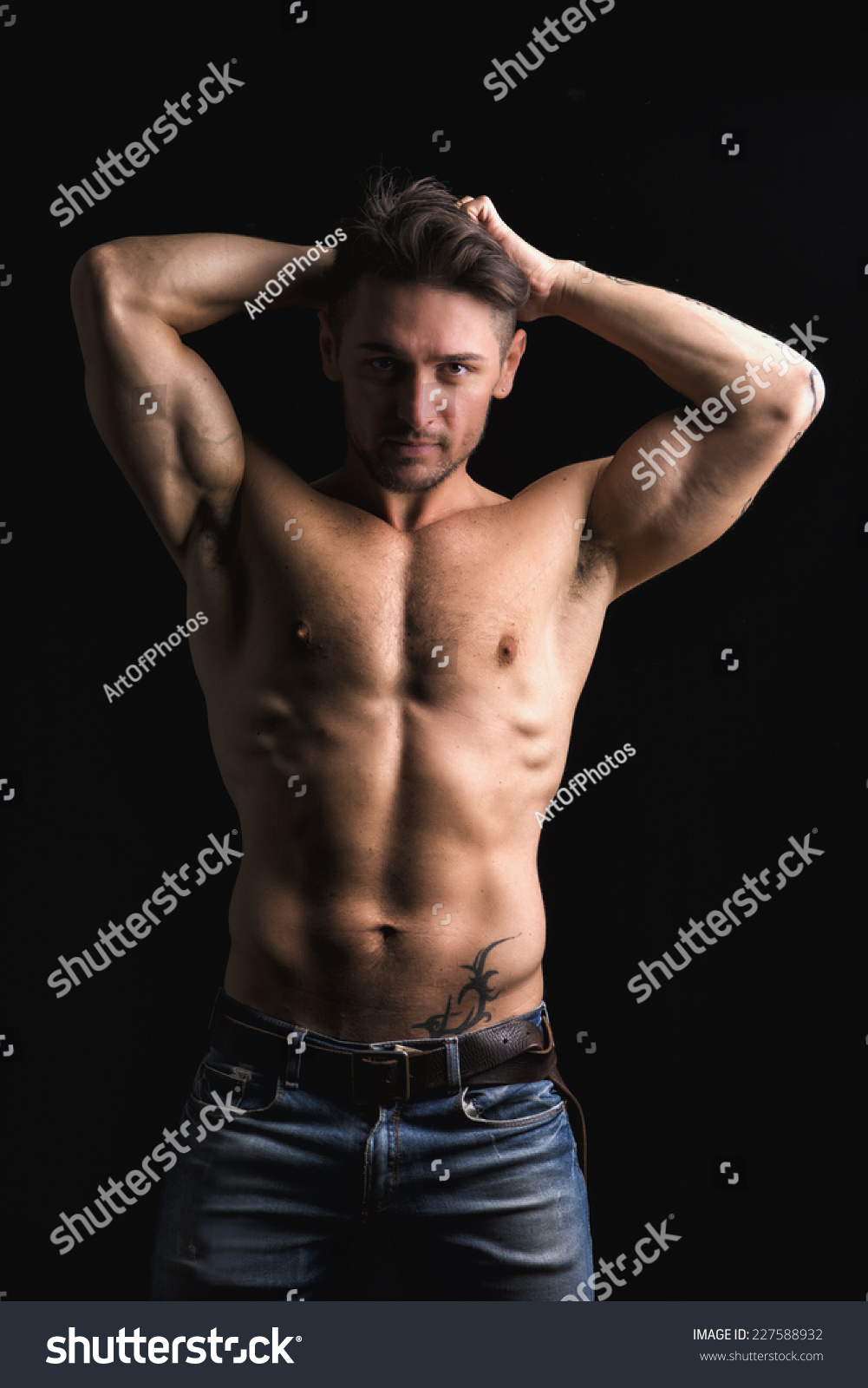 Handsome Muscular Shirtless Young Man Looking At Camera With Hands Behind Head Isolated On