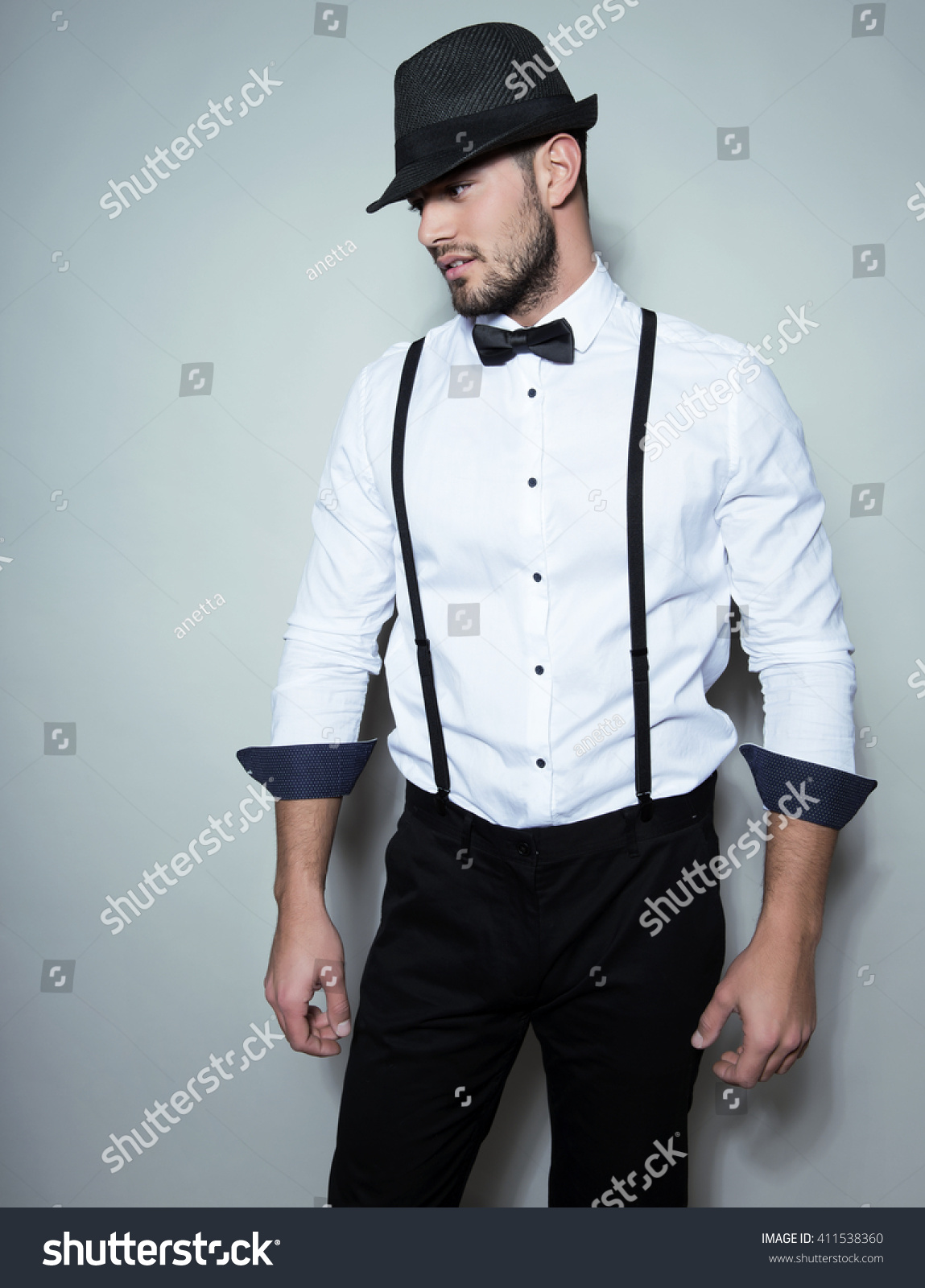 black shirt with red bow tie and suspenders