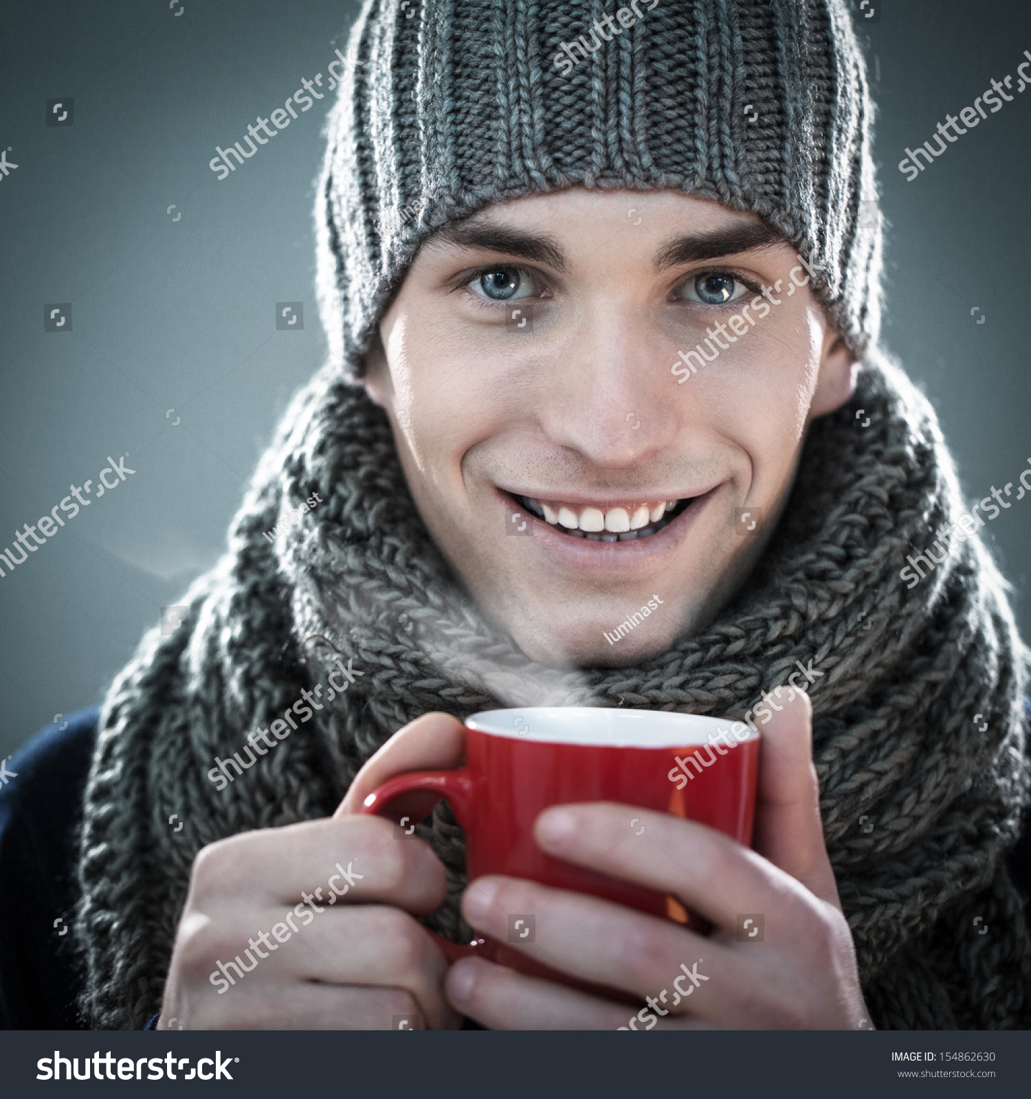 Handsome Young Man In Winter Clothes Holding A Cup Of Hot Tea. Stock ...