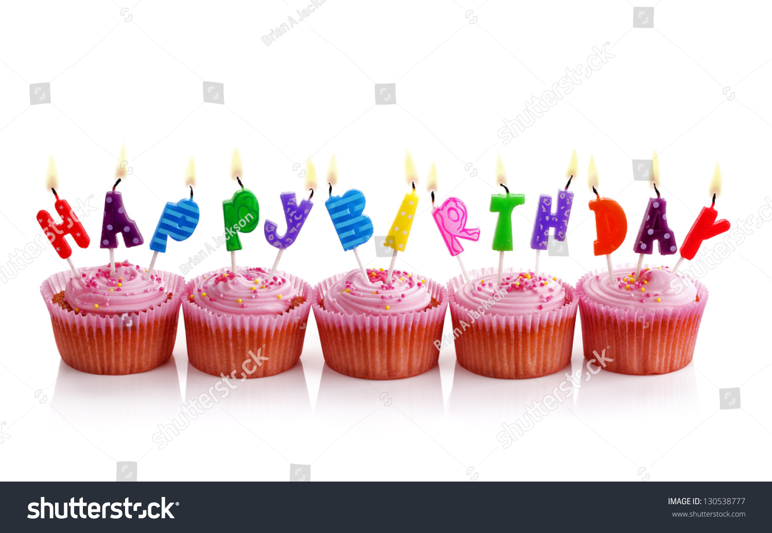 Happy Birthday Candles On Pink Cupcakes Isolated On White Stock Photo ...