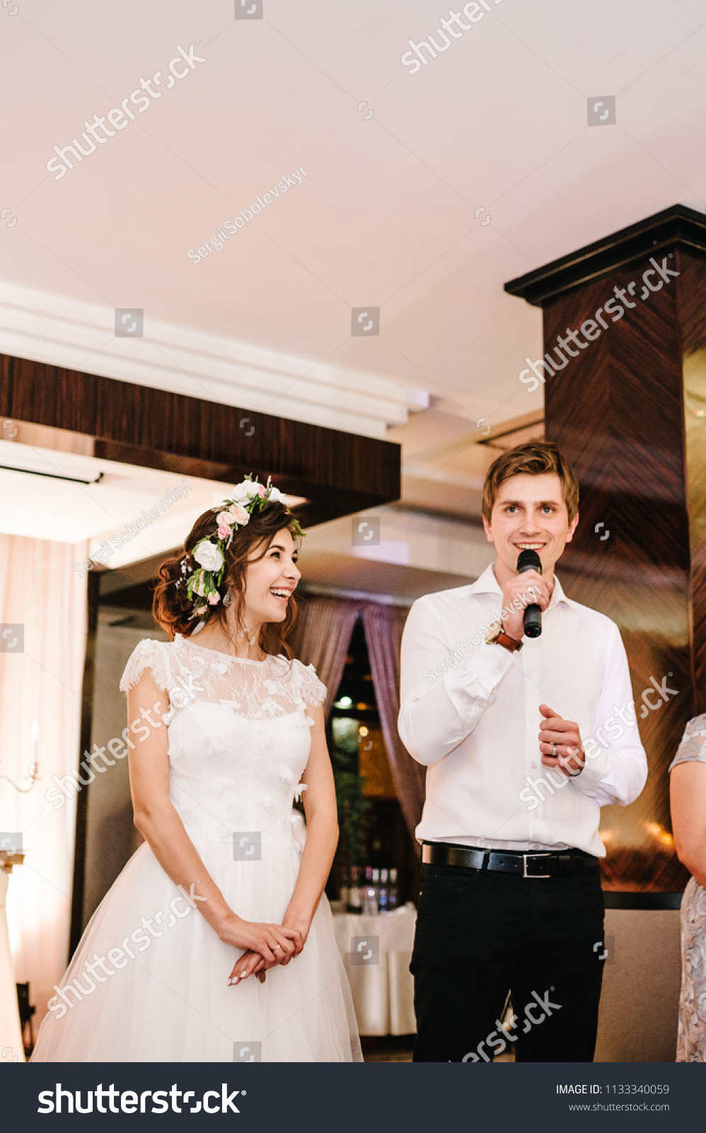 stock photo happy bride and groom talk in a microphone toast to give thanks to their parents for celebrating 1133340059
