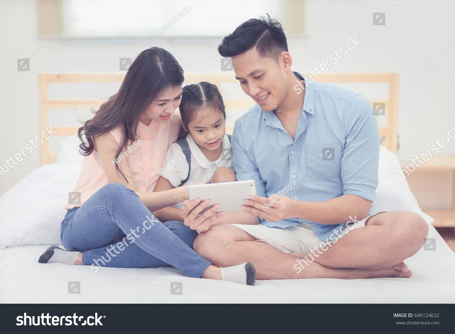 Happy Family Bedroomasian Father Mother Watching Stock Photo