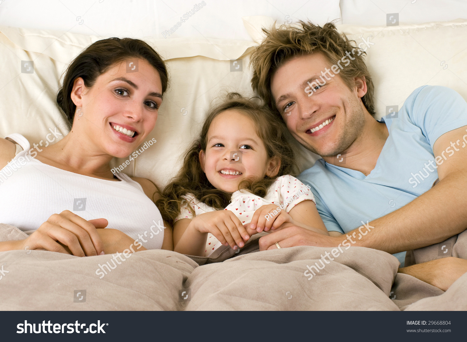 Happy Family Laying In Bed Stock Photo 29668804 : Shutterstock