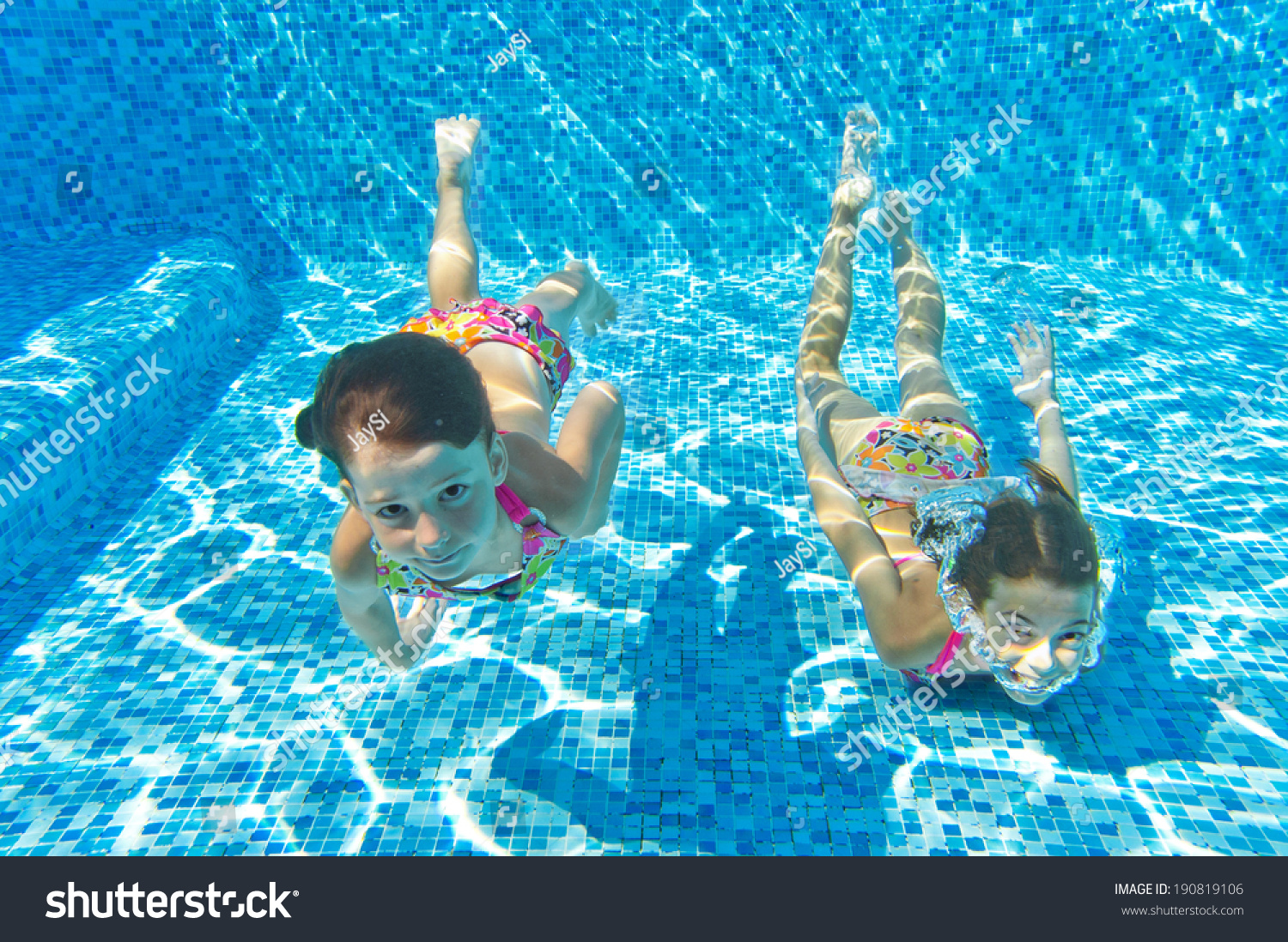 happy kids swim underwater in pool and having fun children on summer vacation sport - Kids Swimming Underwater happy kids swim underwater in pool and having fun children on summer vacation sport - Kids Swimming Underwater