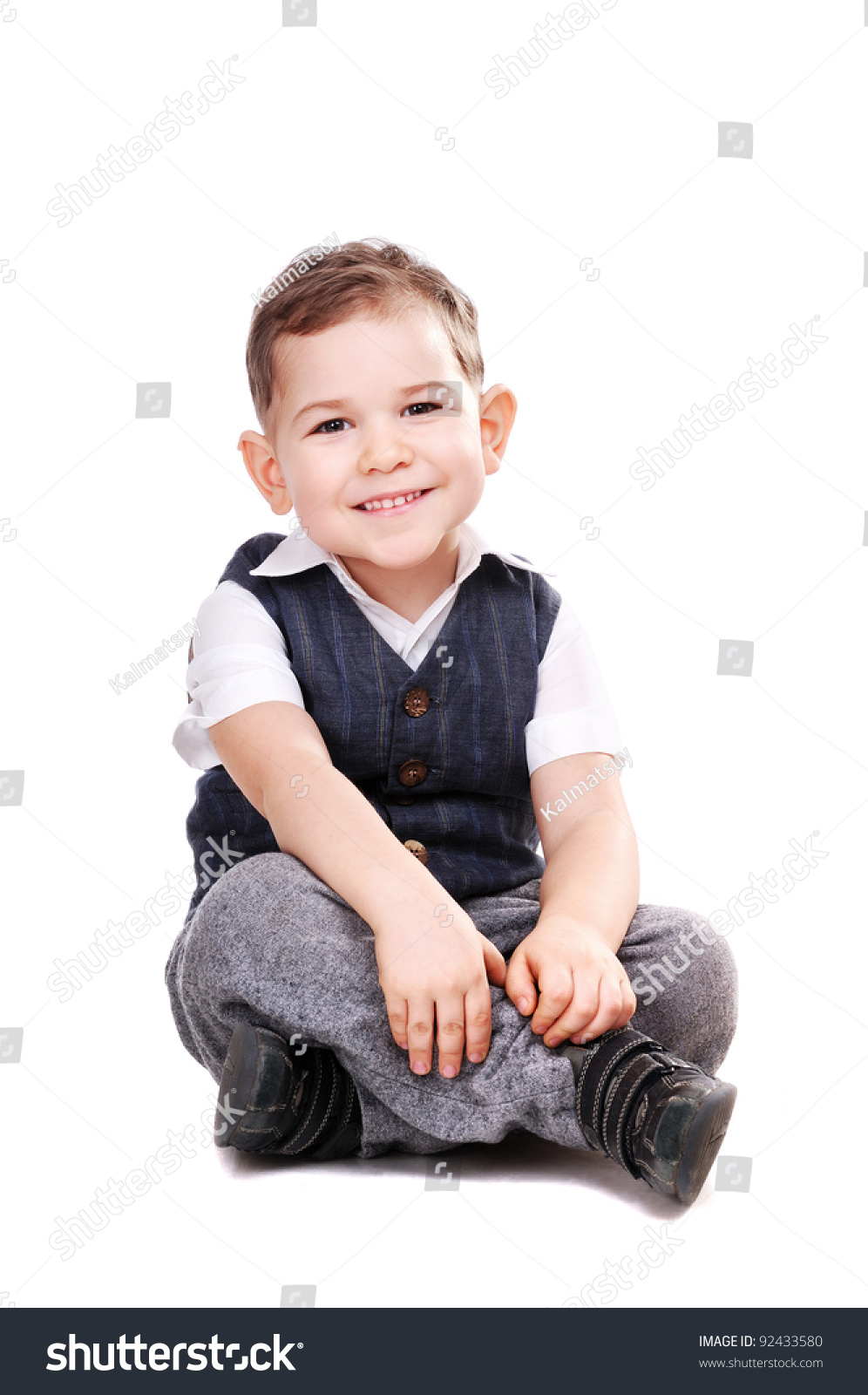 Happy Little Boy Sitting On The Floor Over The White Background Stock ...