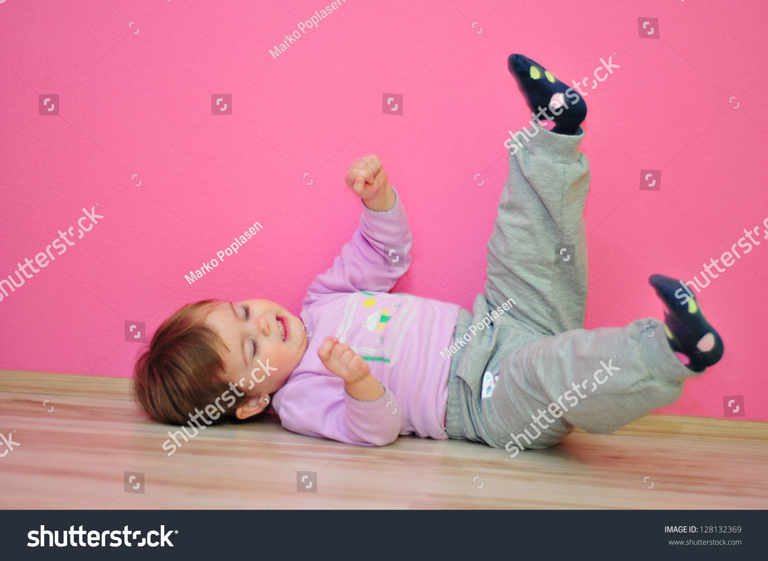 happy-little-girl-lying-on-the-floor-stock-photo-128132369-shutterstock