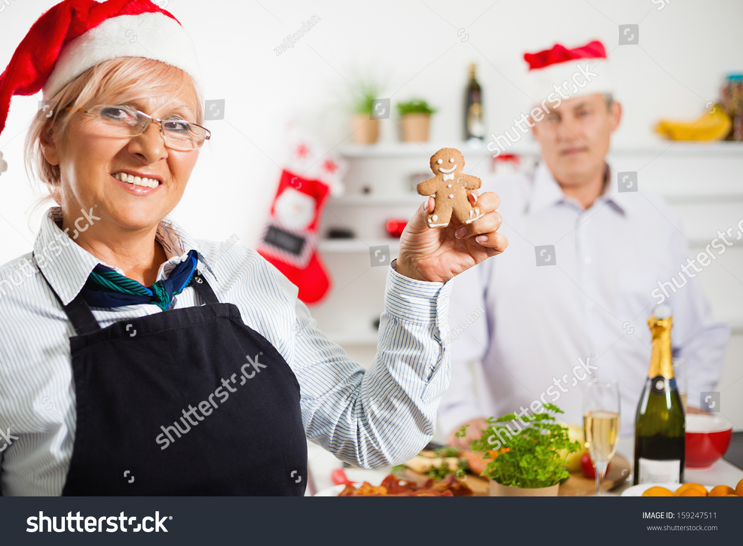 Happy Mature Couple Baking Christmas Cookies. Focus Is On Woman. Stock ...