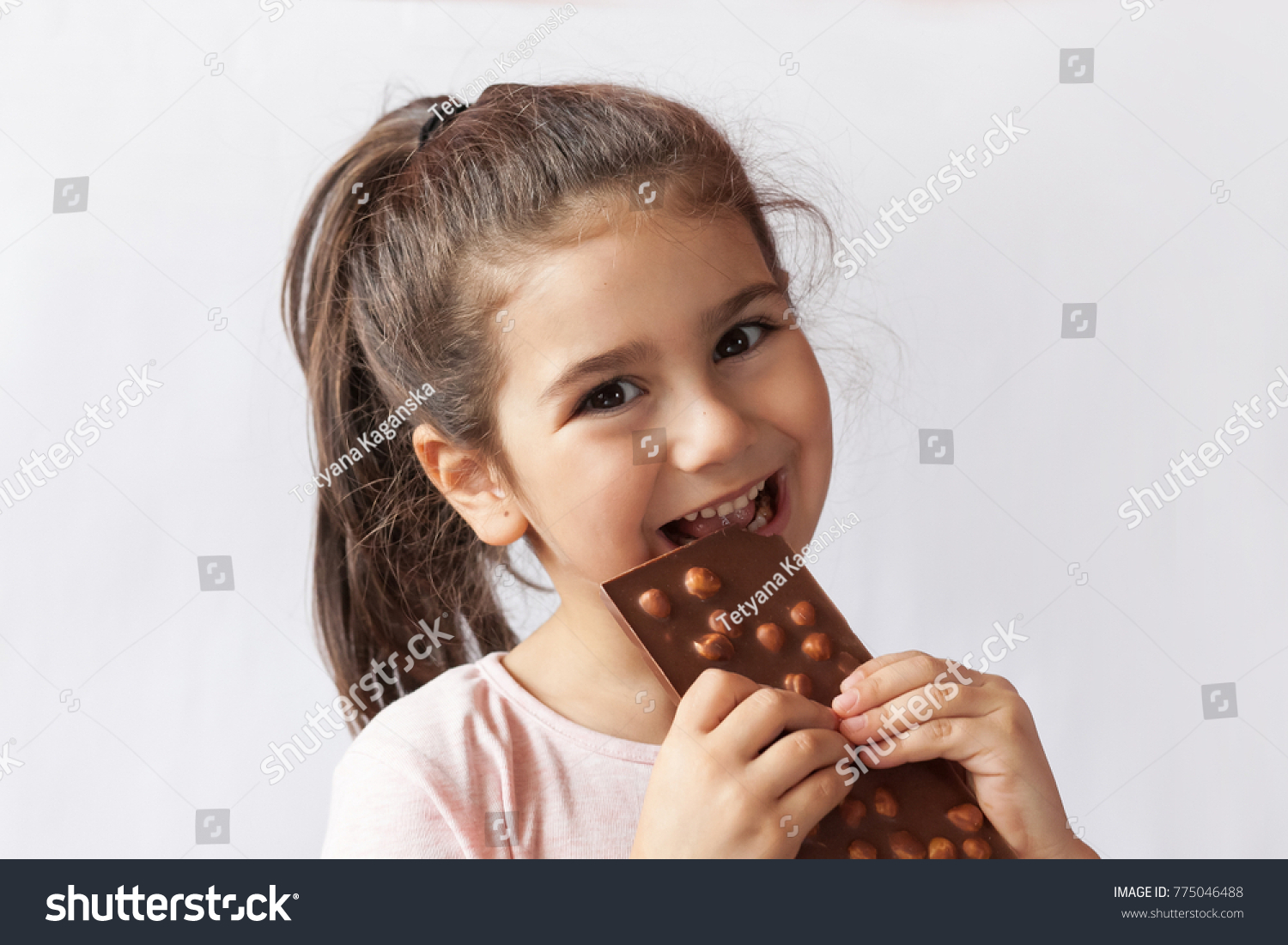 Happy Smiling Kid Girl Biting Tasty Stock Photo (Edit Now) 775046488