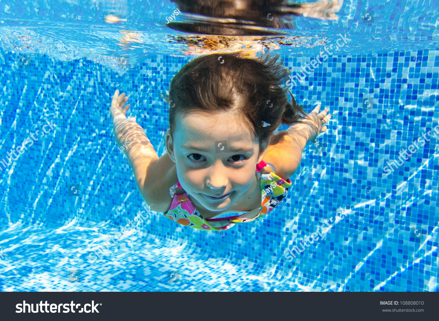 Happy Smiling Underwater Child In Swimming Pool, Beautiful Girl Swims ...