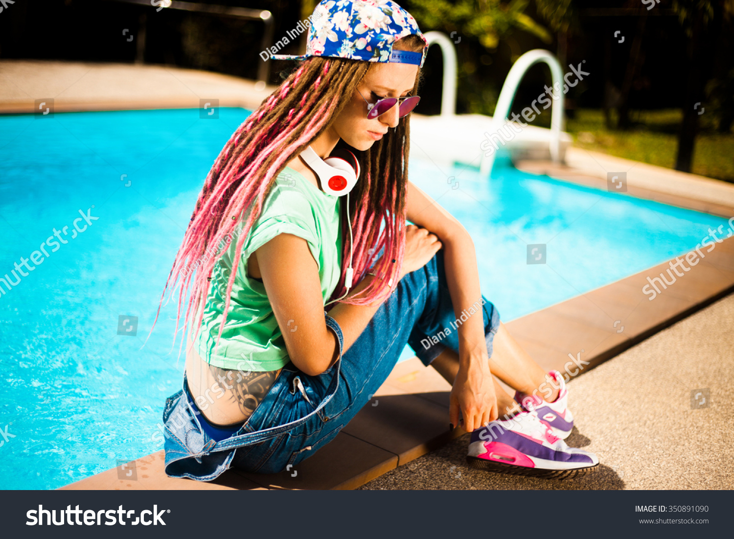 Hipster teen girl,wear swag cap,enjoy music on her big headphones,earphones