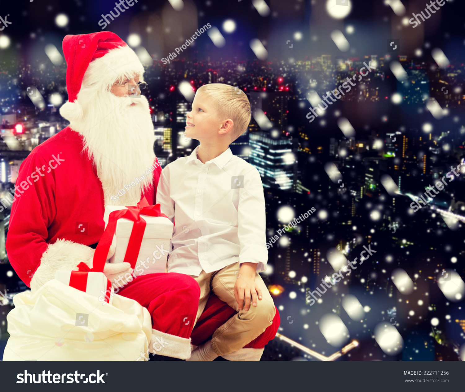 Holidays, Christmas, Childhood And People Concept - Smiling Little Boy With Santa Claus And