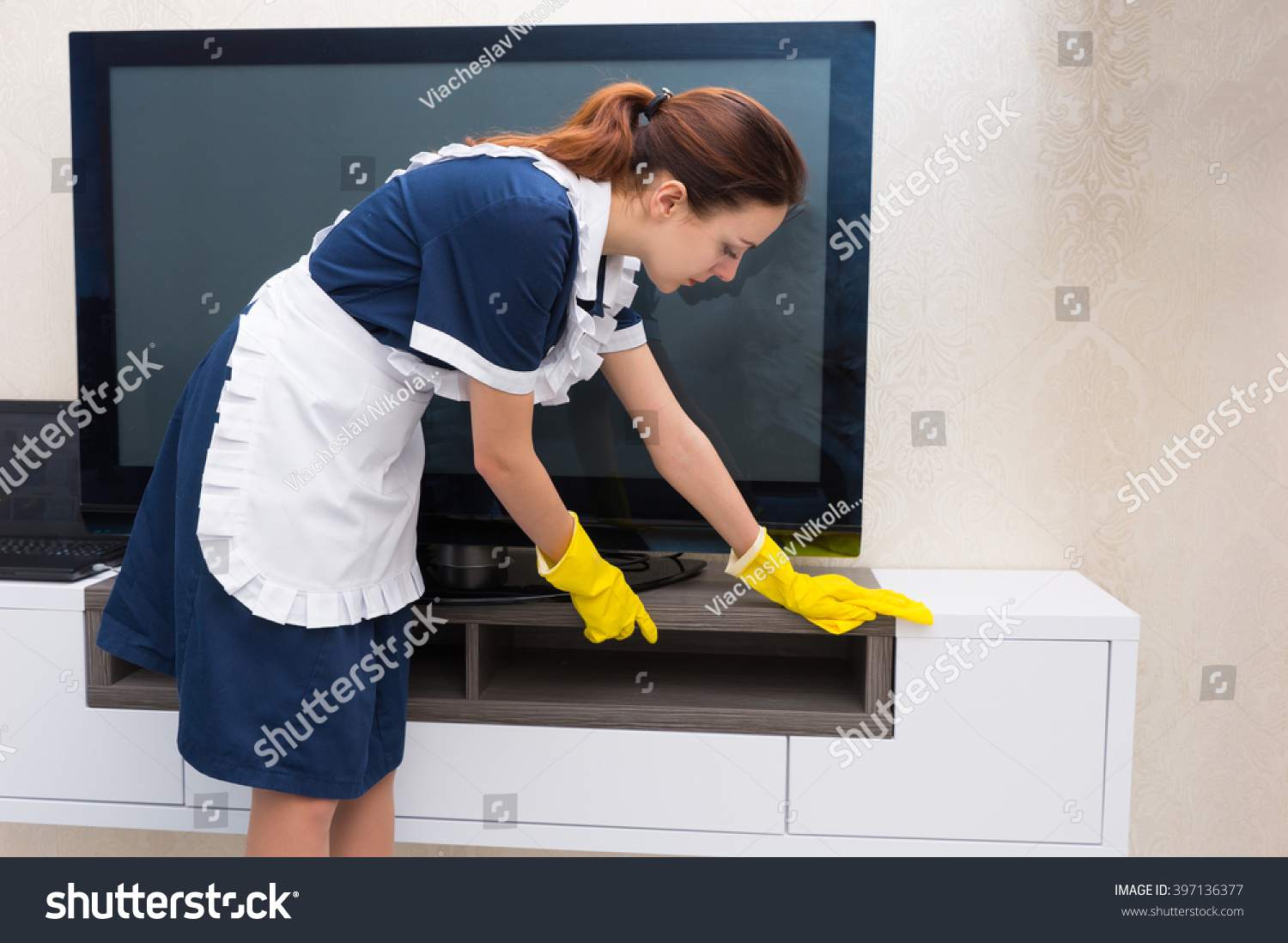 Housekeeper, Maid Or Char In A Neat Uniform And White Apron Dusting A ...