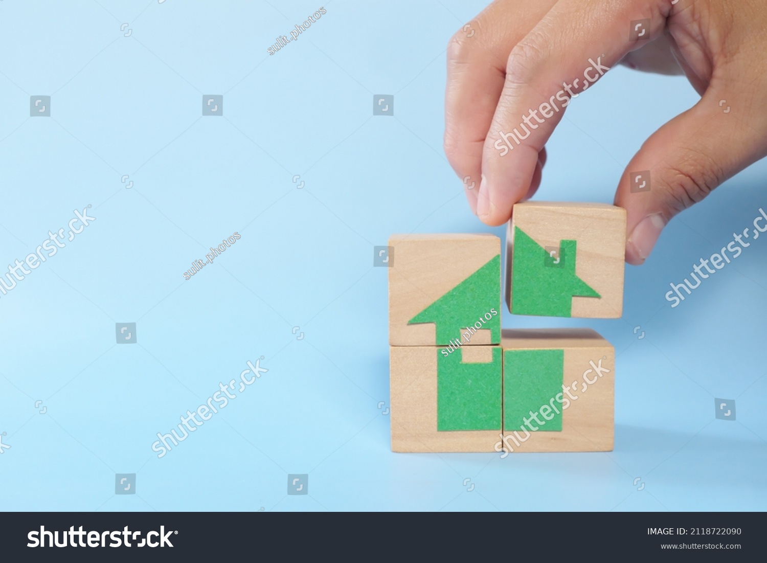 human-hand-putting-together-house-icon-stock-photo-2118722090