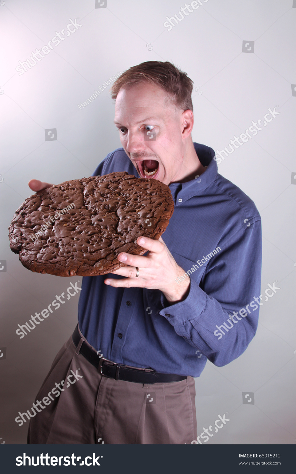 Hungry Man Eating A Giant Cookie Stock Photo 68015212 : Shutterstock