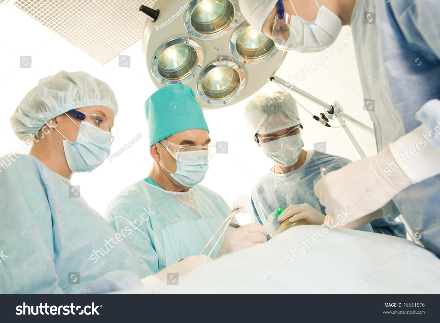 Image Of Surgeons And Nurses Near Patient Lying On Operating Table ...