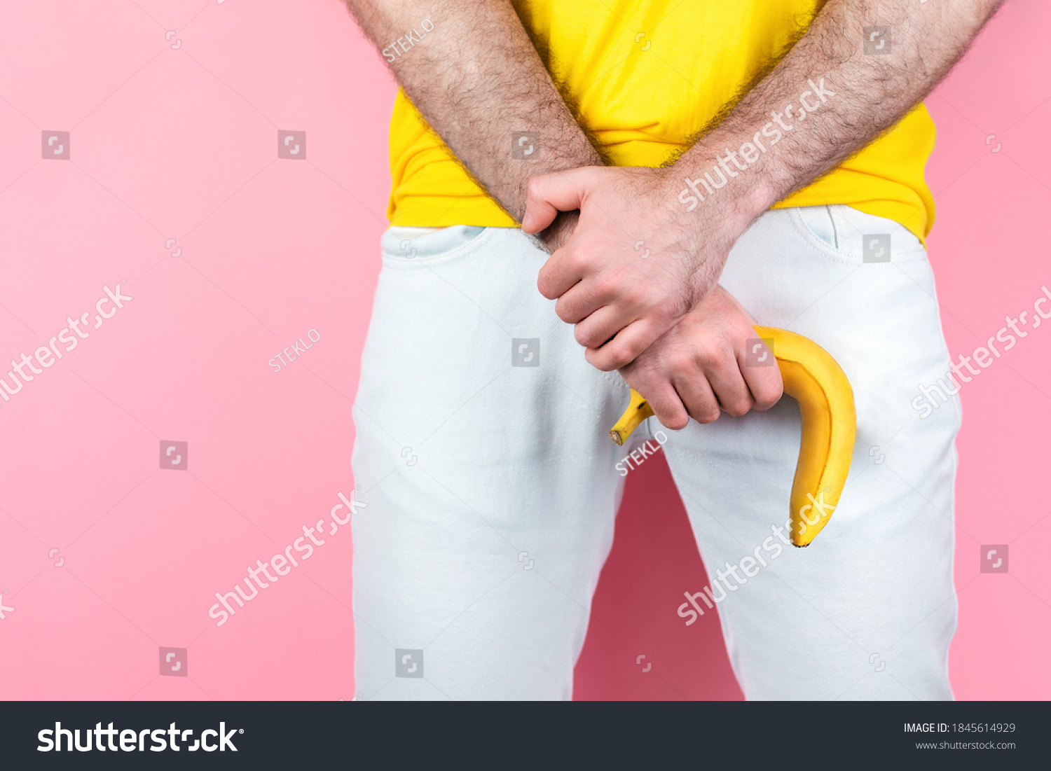 stock-photo-impotence-and-men-s-health-a-man-in-white-jeans-legs-apart-holds-a-limp-banana-near-the-genitals-1845614929.jpg