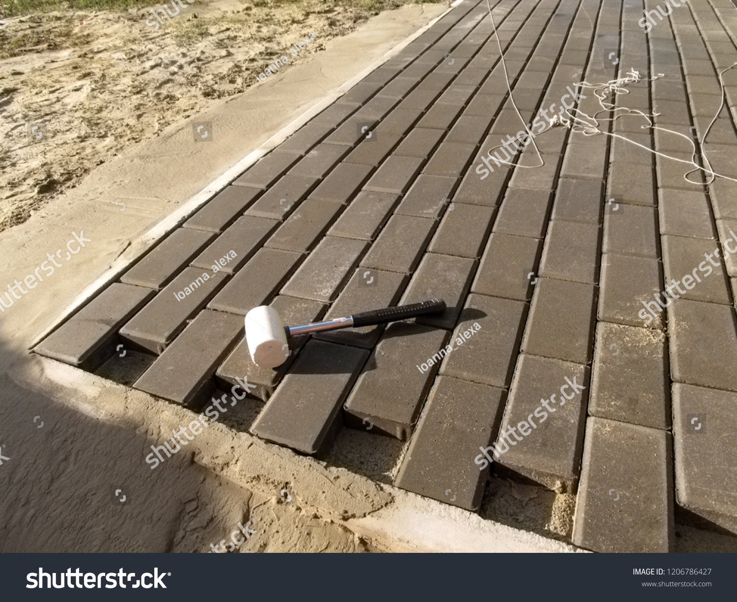 laying paving slabs on sand and cement