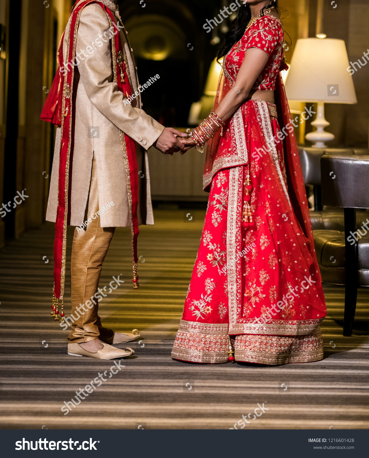 red lehenga bride and groom
