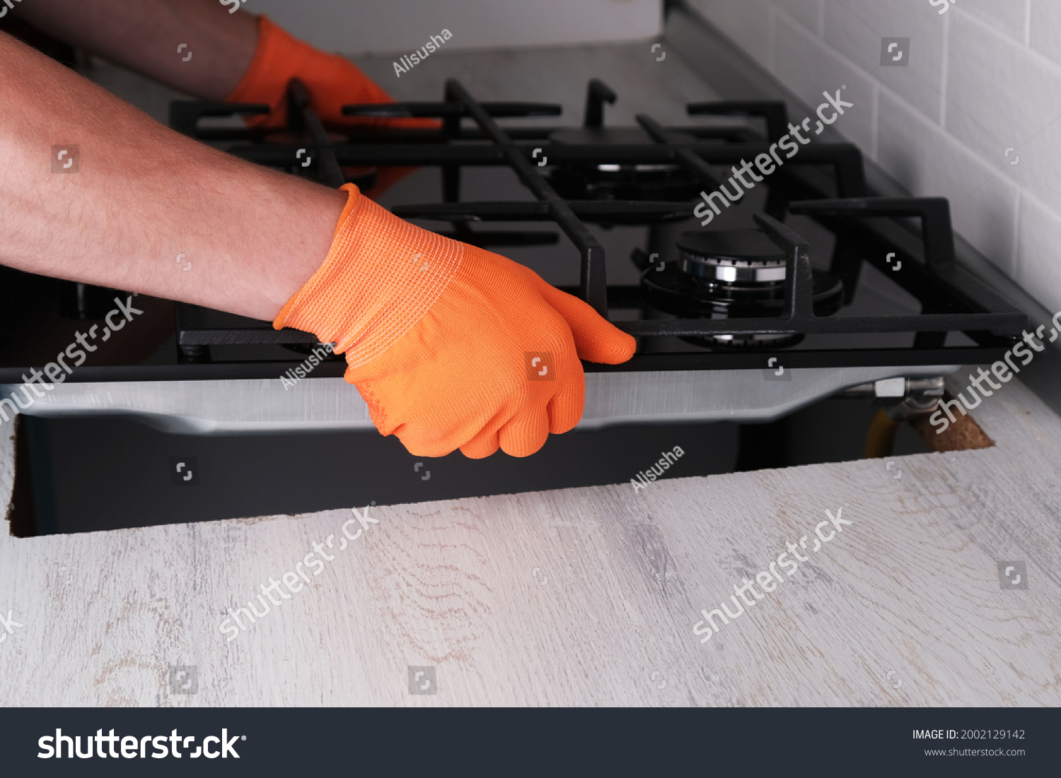 Stock Photo Installing Gas Hob In Kitchen Set Hands Of Master Close Up 2002129142 