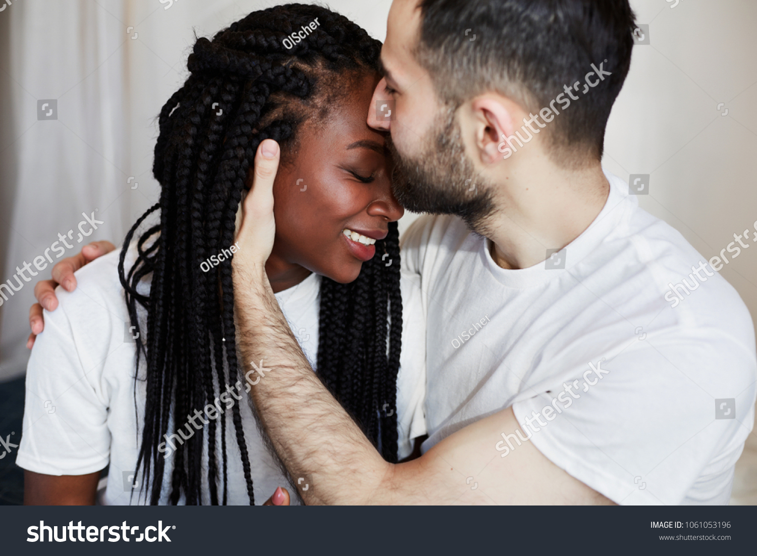 https://image.shutterstock.com/z/stock-photo-international-couple-african-american-girl-and-white-man-hugging-on-bed-1061053196.jpg