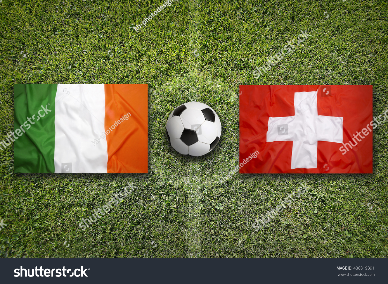 Ireland Vs. Switzerland Flags On Green Soccer Field Stock Photo