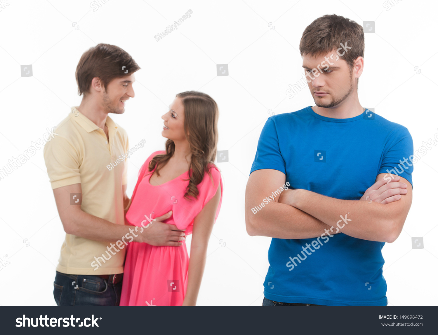 stock-photo-jealousy-young-sad-man-standing-with-his-arms-crossed-while-another-man-and-woman-hugging-on-149698472.jpg