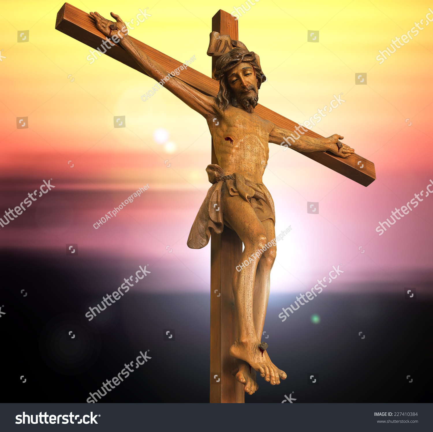 Jesus Christ With The Cross Over Blurred Sunset Background Stock Photo ...