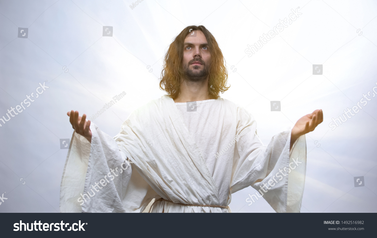 Jesus Raising Hands Heaven On Illuminated Stock Photo 1492516982 ...