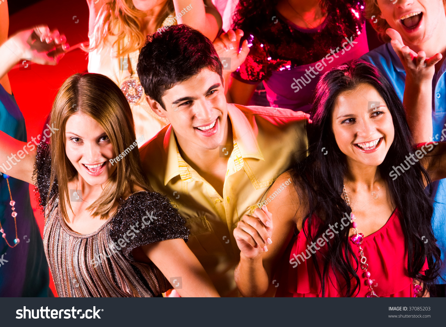 Joyful Teens Enjoying Themselves In Night Club While Dancing Stock ...