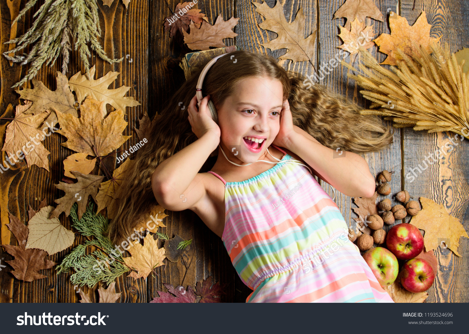Kid listen music headphones wooden background child listen music relaxing top view fall melody