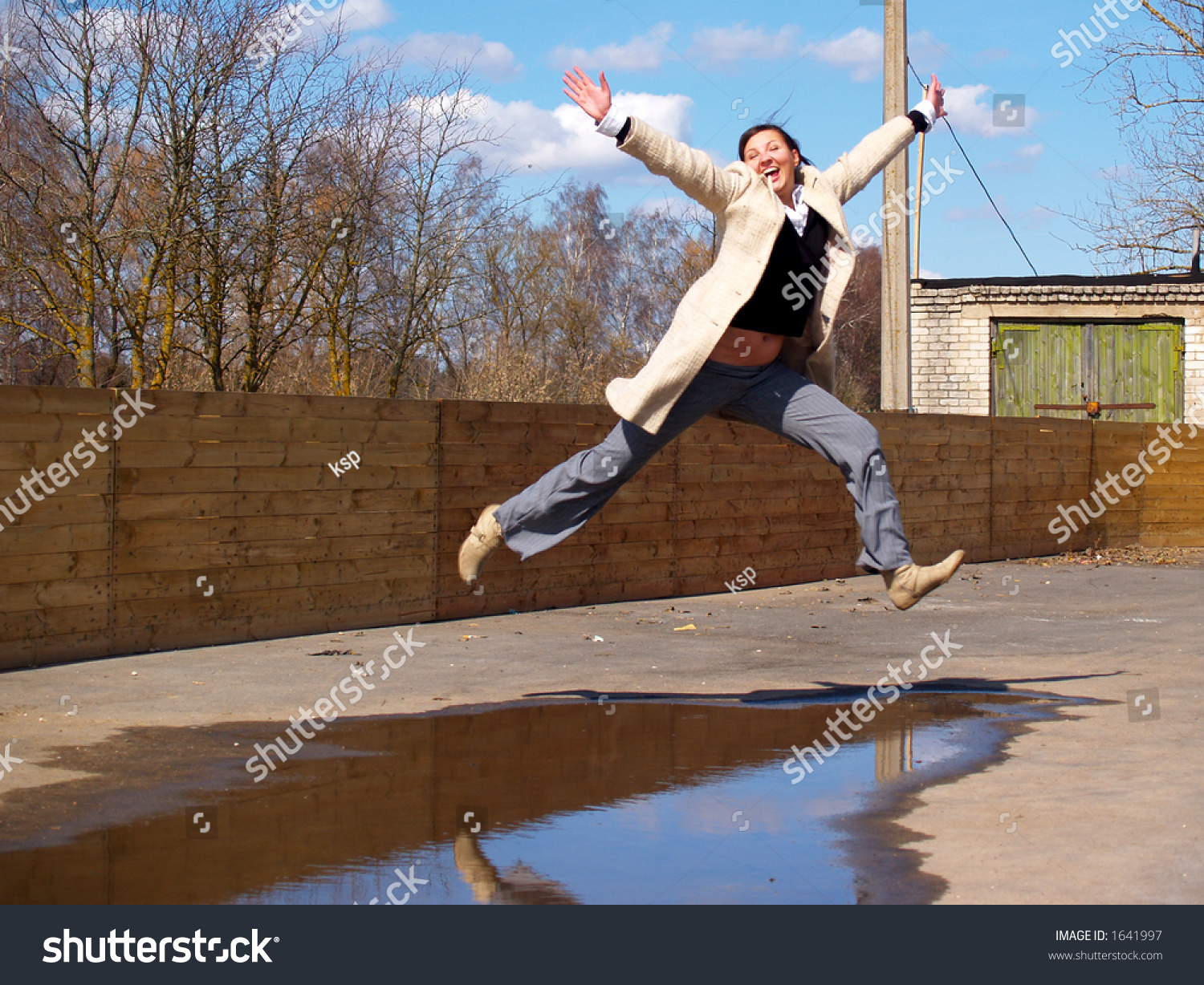 Lady In Grey Coat Jumping Over A Water Puddle Stock Photo 1641997 ...