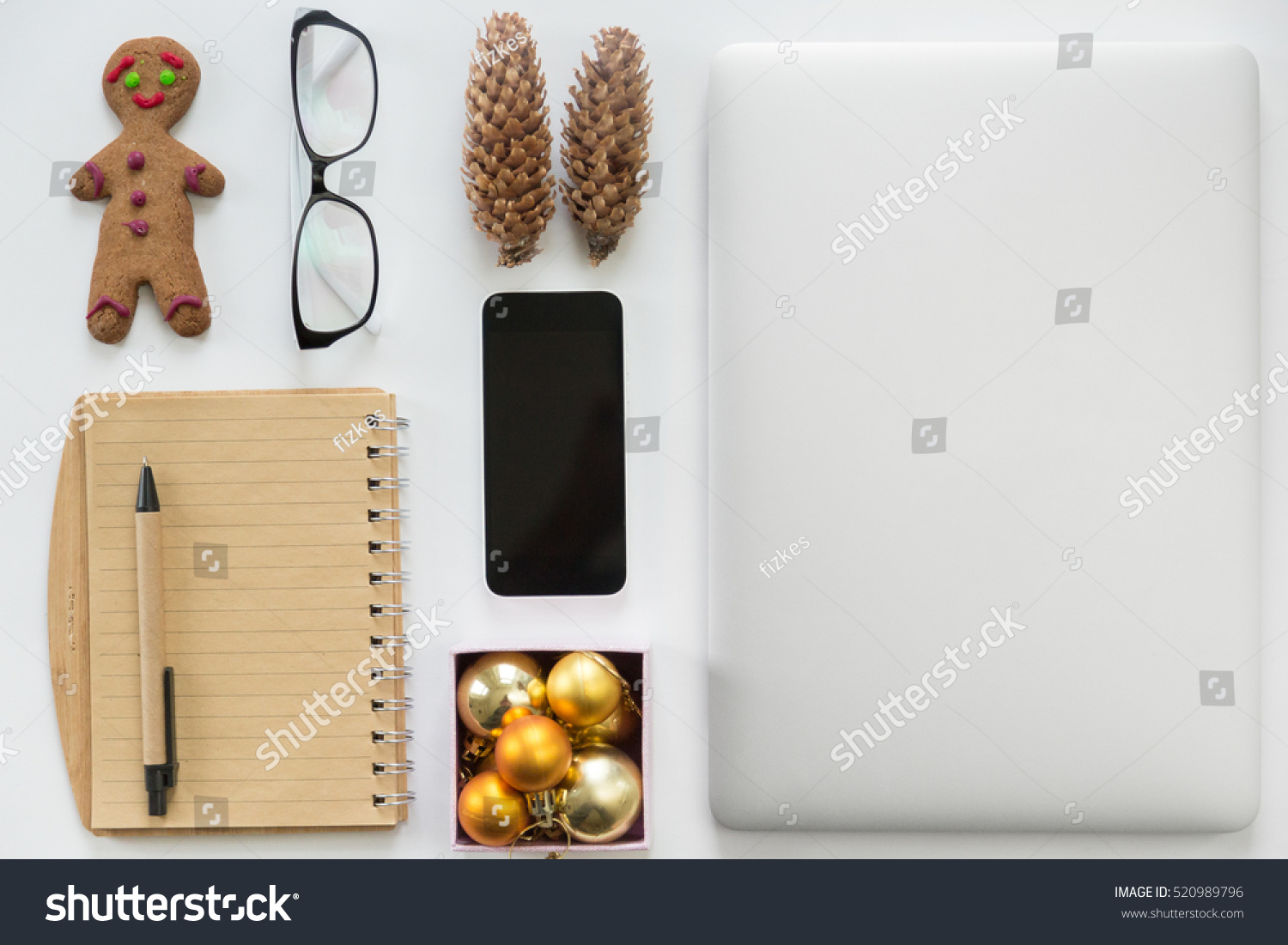 laptop closed mobile phone office supply and christmas decoration on a white office desk - Office Supply Christmas Decorations laptop closed mobile phone office supply and christmas decoration on a white office desk - Office Supply Christmas Decorations